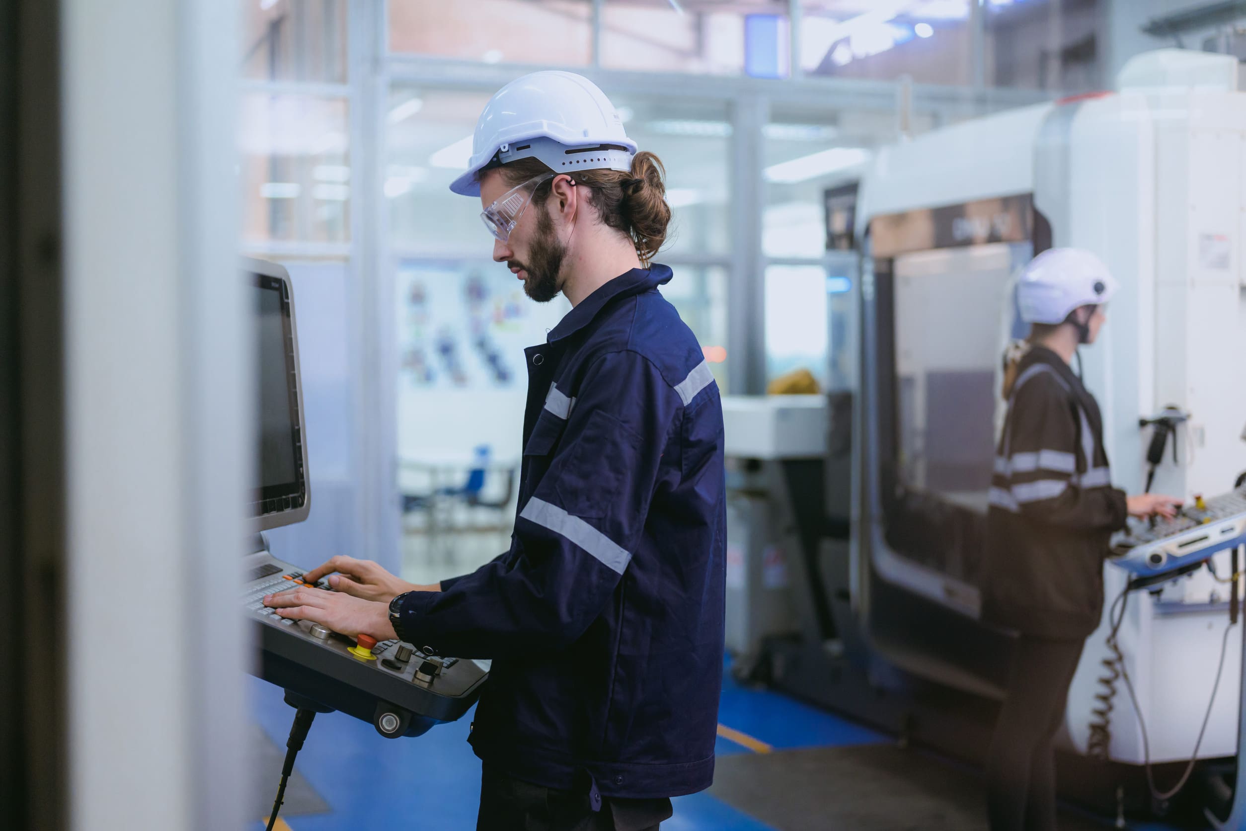 CNC machine operator at HMI control panel — manufacturing IT and OT security Western Massachusetts