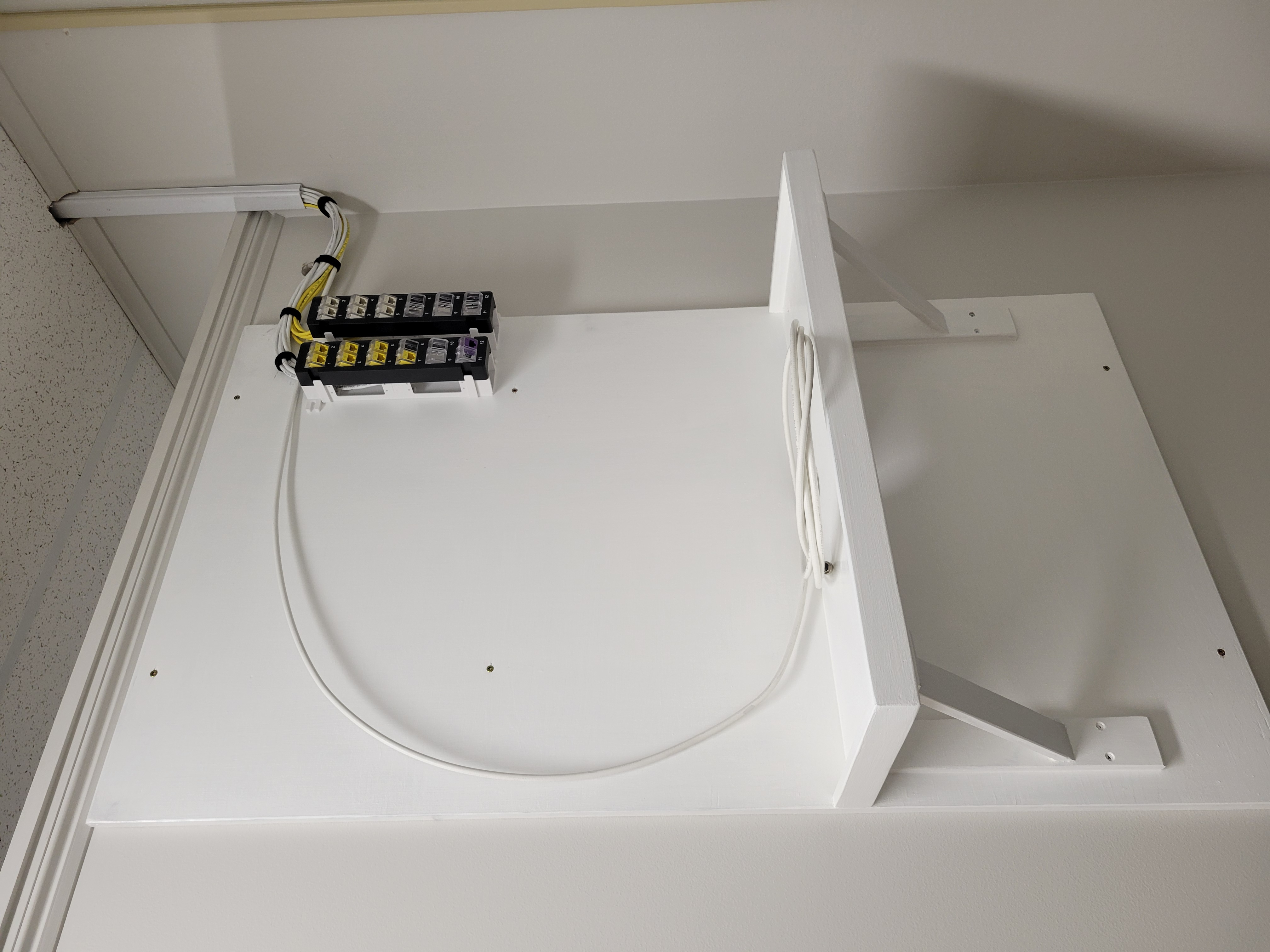 Custom IT shelving mounted at client site — ready for equipment installation